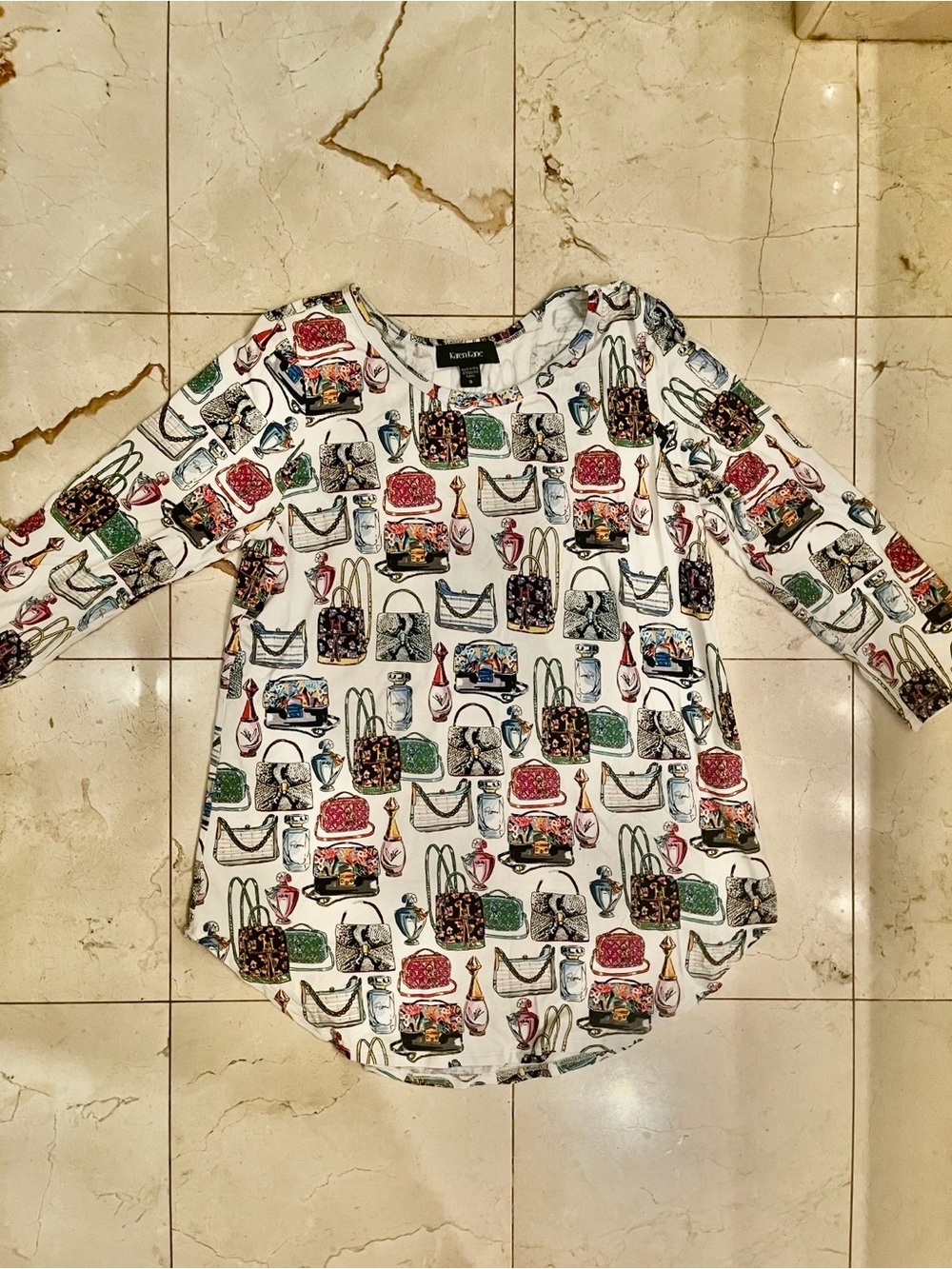 Beautiful Karen Kane Perfume and handbag print 3/4 SleeveTop.